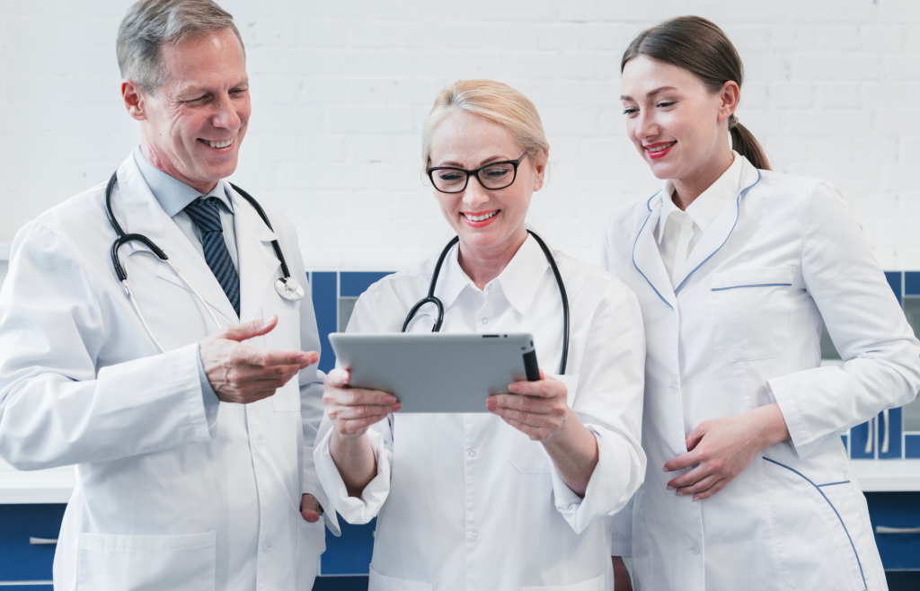 Reshaping Patient Care, Diagnostics, and Remote Monitoring with FHIR AI in Healthcare 5 Healthcare practitiones checling info from medical tools