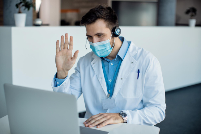 Doctor waving during video call